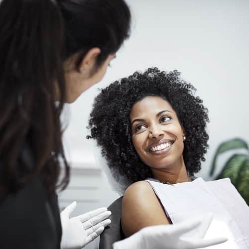 A female patient discussing treatment options with her dentist
